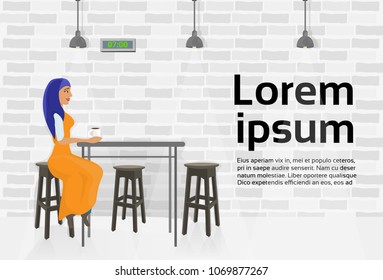 Arab Woman Drinking Coffee In Modern Cafe Sitting At Table Over Copy Space