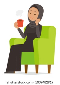 An Arab Woman Wearing Ethnic Costumes Is Sitting On A Sofa And Drinking Coffee