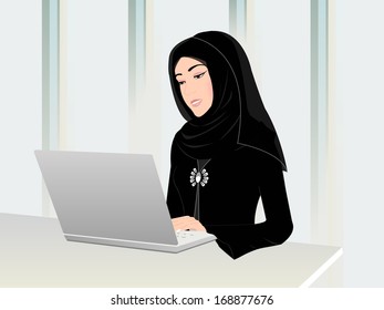 Arab woman working on a computer in an office wearing her traditional black Arabic dress and a head scarf.