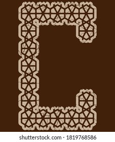 Arabesque style decorative letter.Brown cracked font.