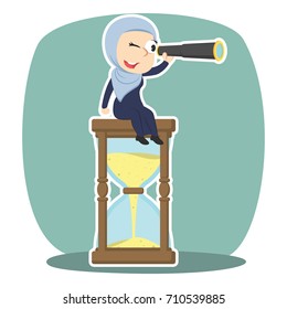 arabian businesswoman is using binocular on hourglass