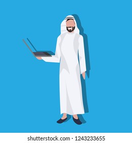Arabic business man using laptop wearing traditional clothes arab businessman male cartoon character avatar blue background full length flat