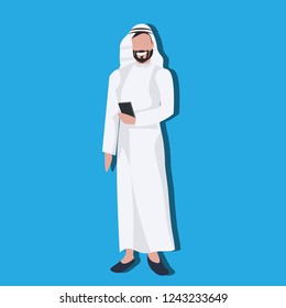Arabic business man using smartphone wearing traditional clothes arab businessman male cartoon character avatar blue background full length flat
