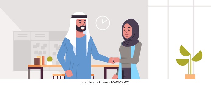 arabic businesspeople man woman handshaking arab business partners couple hand shake during meeting agreement partnership concept modern co-working center office interior portrait horizontal