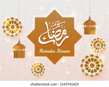Arabic Calligraphy Of Ramadan Kareem Over Rub El Hizb Frame With Paper Cut Lanterns And Floral Decorated Bokeh Background.