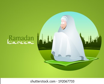 Arabic islamic calligraphy of text Ramadan Kareem with young muslim girl praying in tradition clothes on mosque silhouette background.