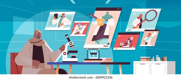 arabic researcher making chemical experiments on microscope in laboratory and discussing with arab scientists during video call