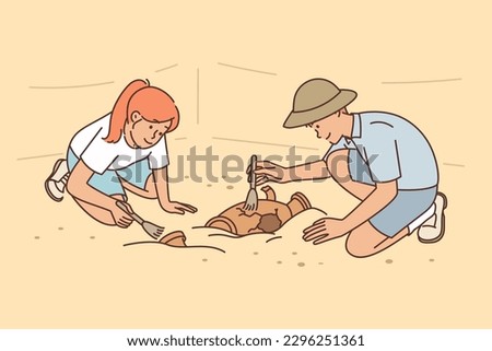 Archaeologists at excavations of ancient city clean artifacts of medieval civilizations at site of old temple. Young man and woman working archaeologists found ancient burials of cultural value Foto d'archivio © 