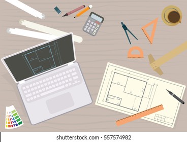 Architect designer engineer workplace with equipment. 
Top view of architects work desk with laptop, plans a equipment.