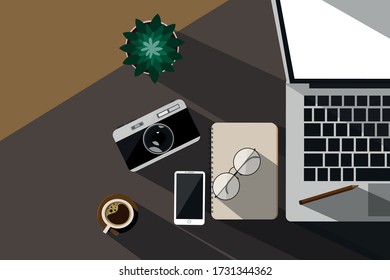 The area of ​​the work desk, top view, computers, digital devices and notebooks, coffee cameras