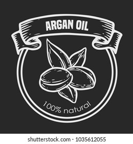 Argan vector drawing  label nut oil, fruit, berry, leaf, branch, plant. Hand drawn engraved vector sketch etch illustration. Ingredient for hair and body care butter, beauty and spa lotion.