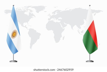 Argentina and Madagascar flags for official meeting against background of world map.