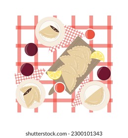 Argentinian empanadas with red wine on a table.