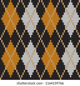 Argyle print. Seamless knitted pattern with rhombuses. Checkered background in orange, black and white colors. It can be used as a Halloween background. Vector illustration