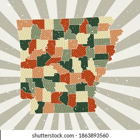 Arkansas vintage map. Grunge poster with a map of the US state in a retro color palette. The shape of Arkansas is highlighted with a sunburst rays background. Vector illustration.