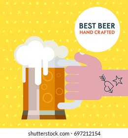 Arm with a tattoo holding a mug of beer. The best beer. A colorful poster advertising beer.