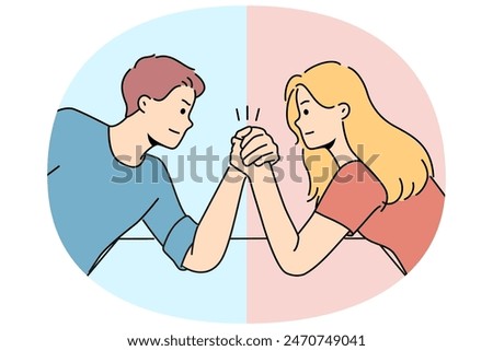 Arm wrestling between couple of man and woman for concept of fighting for leadership in family. Guy with girl compete who is stronger competing for position in company or leadership in team