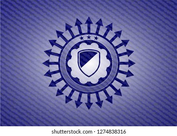 armor icon inside badge with denim background