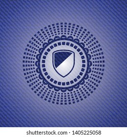 armor icon inside badge with denim background