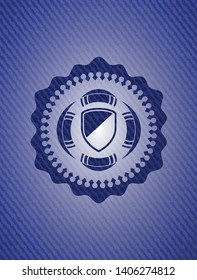 armor icon inside badge with denim background