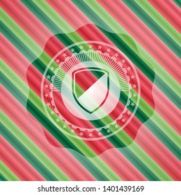 armor icon inside christmas style emblem.