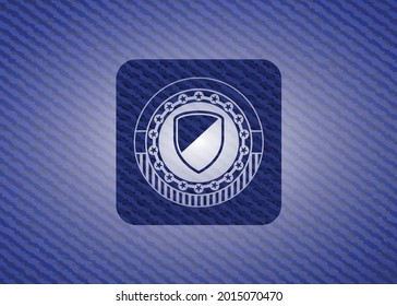 armor icon inside denim background. 
