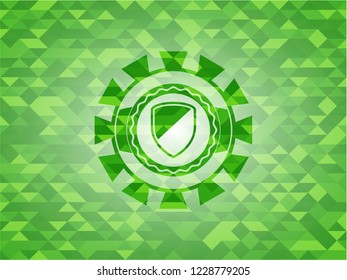 armor icon inside green emblem with triangle mosaic background