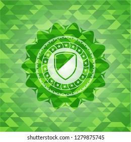 armor icon inside green emblem with mosaic background
