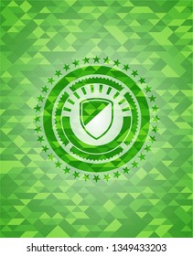 armor icon inside green emblem with mosaic background