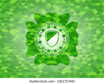 armor icon inside green emblem with mosaic ecological style background