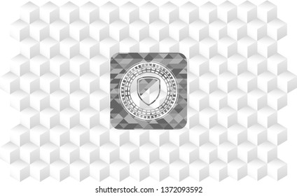 armor icon inside grey badge with geometric cube white background