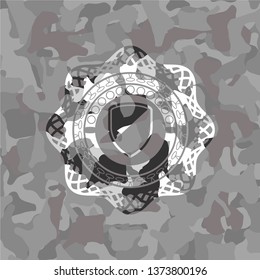 armor icon inside grey camouflage emblem