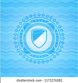 armor icon inside light blue water wave emblem.