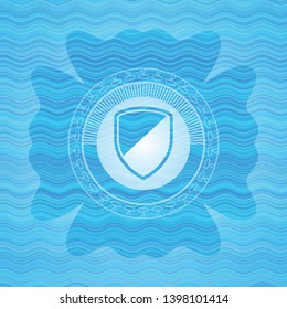 armor icon inside light blue water style emblem.