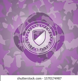 armor icon inside pink and purple camouflaged emblem
