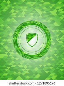 armor icon inside realistic green mosaic emblem