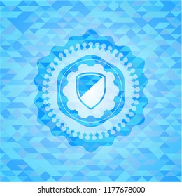 armor icon inside realistic light blue emblem. Mosaic background