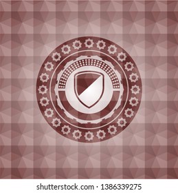 armor icon inside red seamless emblem with geometric background.