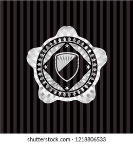armor icon inside silvery emblem or badge