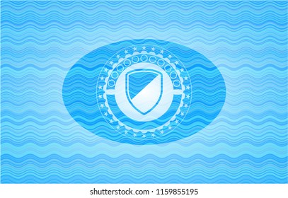 armor icon inside sky blue water wave badge.