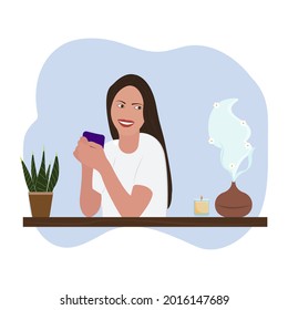 Aroma oil or humidifier air diffuser, houseplants, burning candle and young beautiful woman at the table. Woman breathes fresh air at home. Aromatherapy Concept. 