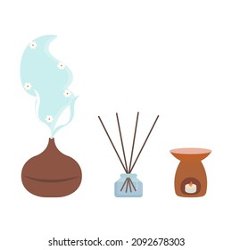 Aromatherapy concept of a home spa and wellness space with diffuser, reed diffuser, oil burner, candles, incense sticks.