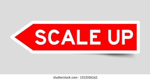 Arrow shape red color sticker in word scale up on gray background