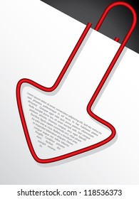 Arrow shaped red paper clip hanging on paper