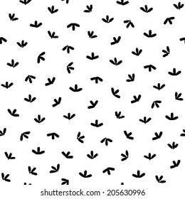 Arrow-looking black brush strokes on white background. Vector seamless pattern with abstract minimalistic tribal style design. 