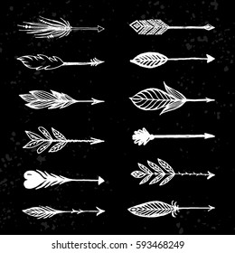 Arrows in native american indian style set. Vector hand drawn illustration arrows isolated on dark background. Design elements in boho, tribal style for cards, flyers