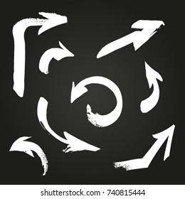 Arrows white vector set on black background. Hand made brush ink arrows. Calligraphy arrows.