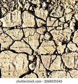 Art background with cracks of clay and white brown.