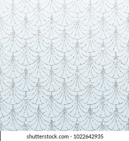 Art deco seamless pattern with silver mermaid scales on sky blue sparkle background.
