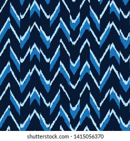 art striped, dip dye  zig zag Seamless ethnic   pattern of indigo color on white silk. Ikat seamless pattern. Vector tie dye shibori print with stripes and chevron. Ink textured japanese background. 